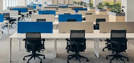 Modern open-plan office space featuring clean workstations, ergonomic chairs, and sanitized carpets provided by professional office cleaning services in Louisville, KY.